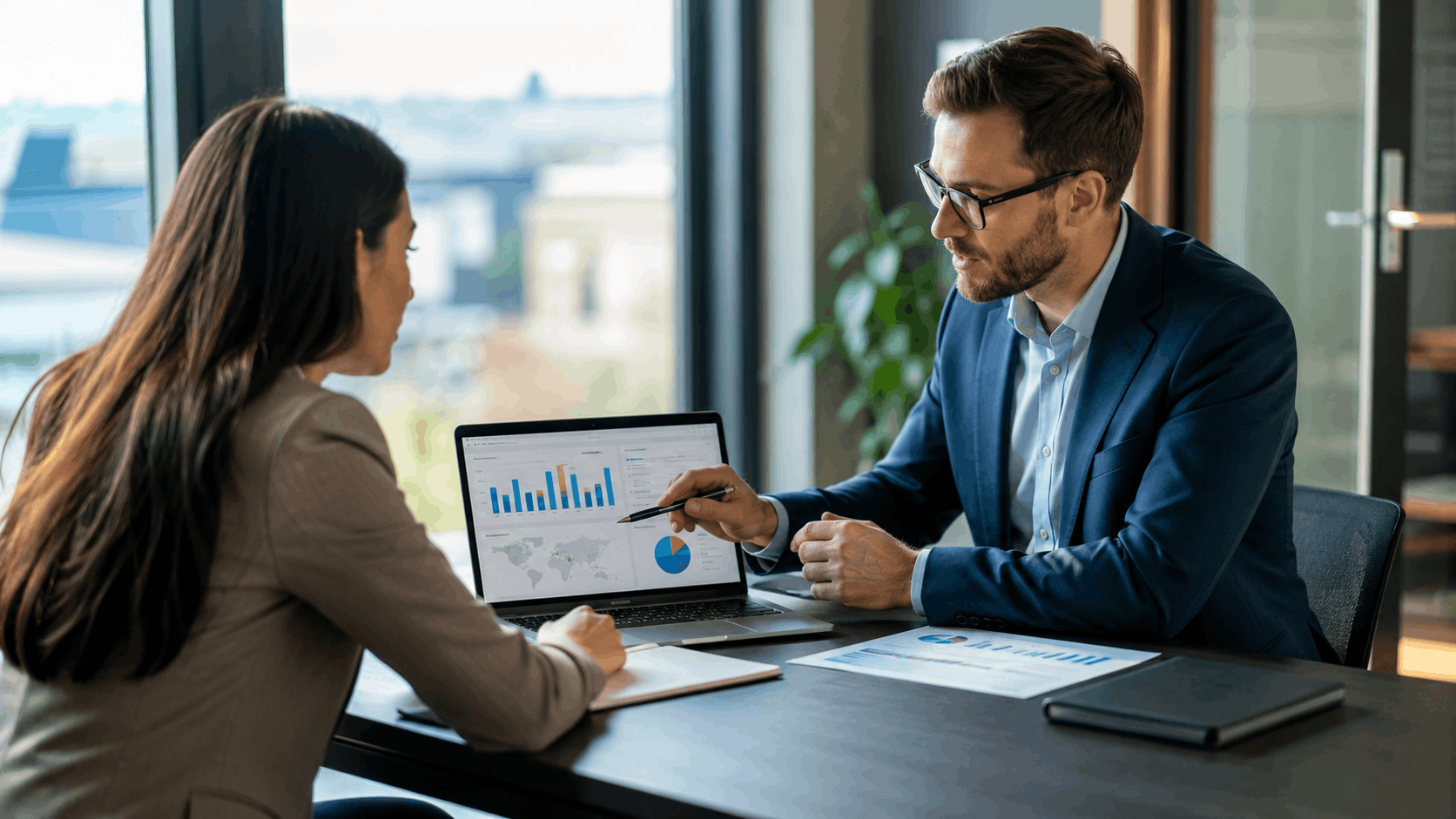Business consultant presenting local SEO data analytics on laptop during client meeting